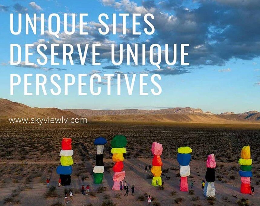 A group of people, filmed by the best Las Vegas drone company, stands together in a vast desert.