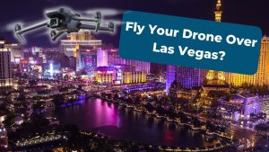 A drone hovers above the brightly lit Las Vegas Strip at night, showcasing colorful landmarks. A blue box with white text asks, Fly Your Drone Over Las Vegas? Explore-top-commercial-drone-pilot-services-in-las-vegas.